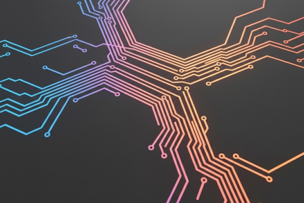 A stylized 3D rendering of a printed circuit board with wide, curving traces on a dark gray background. The traces glow with a color gradient from cool blue to hot orange-red.