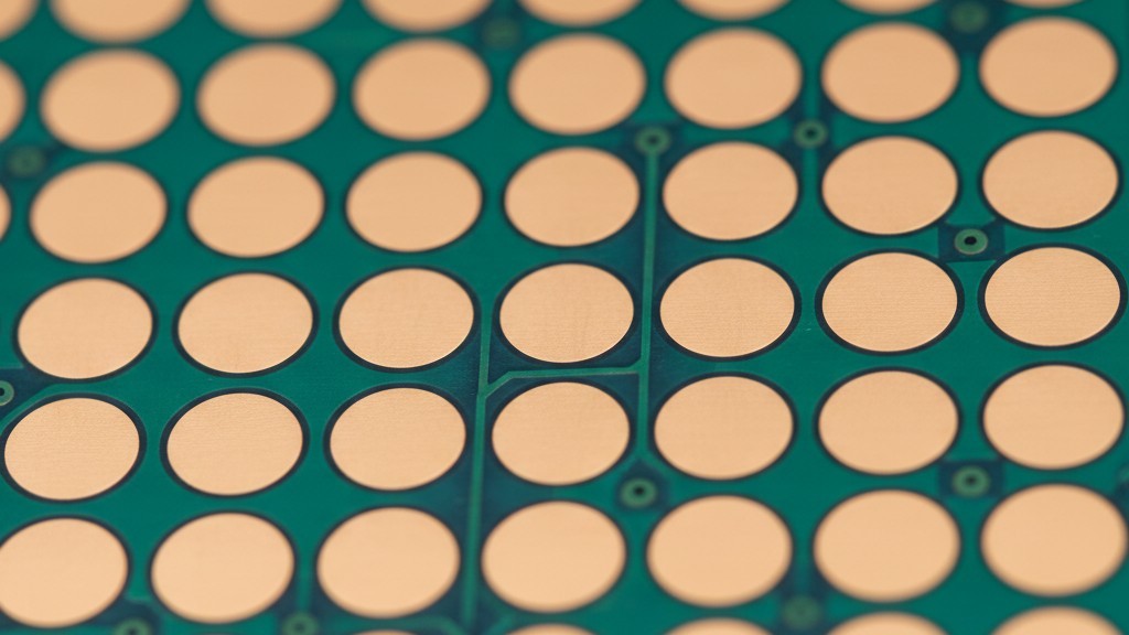 A close-up of a green circuit board shows a grid of small, circular copper pads. The pads are perfectly flat and smooth, showing a correctly manufactured via-in-pad plated over (VIPPO) surface ready for components.